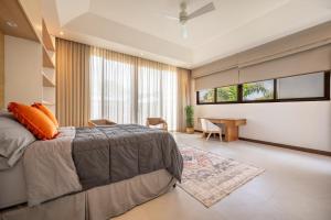 a bedroom with a bed and a desk at Casa Cheetah Main House and Casita in Tamarindo +31 photos