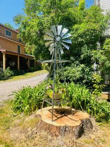 a statue of a windmill on a tree stump at Homesteading at 55 main in Stamford