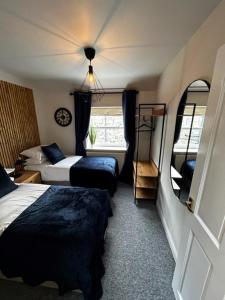 um quarto de hotel com duas camas e uma janela em The Cottage Leyburn em Leyburn