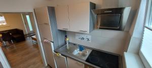 an overhead view of a kitchen with a sink and a microwave at FeWo Nordsee Wohnung 1 in Wangerland +3 photos
