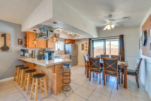 a kitchen and dining room with a counter and chairs at Bullhead City Home Less Than 2 Mi to Colorado River! in Bullhead City