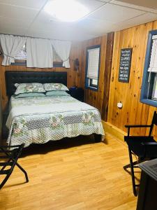 a bedroom with a bed in a room with wooden floors at Homesteading at 55 main in Stamford
