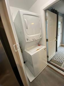 a kitchen with a washer and dryer in a room at Unique & Peaceful Boston Home( Free Parking) in Boston
