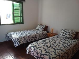 a room with two beds and a window at Famarabeach in Famara