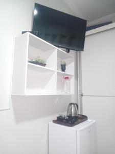 Suíte confortável - banheiro privativo!にあるテレビまたはエンターテインメントセンター