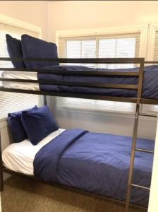 a bedroom with two bunk beds with blue sheets at Revere Lower in Cleveland
