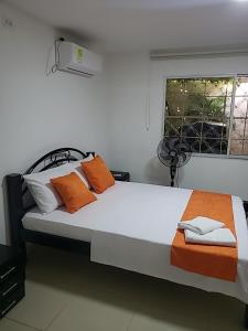 a bedroom with a large bed and a window at La Samaria Casa Linda in Santa Marta