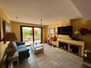 a living room with a couch and a fireplace at Casa de Playa in Estepona