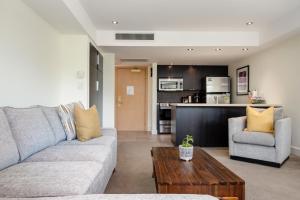 a living room with a couch and a coffee table at Perfect Upper Village Ski In-Ski Out Location in Whistler