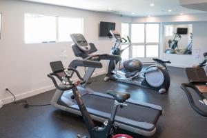 a gym with several exercise bikes in a room at Perfect Upper Village Ski In-Ski Out Location in Whistler