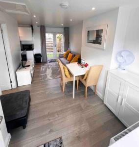 a living room with a table and a couch at Minster Hilltop Apartment in Minster