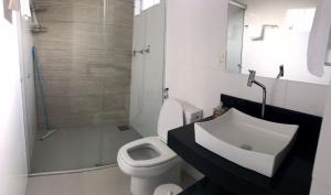 a bathroom with a sink and a toilet and a shower at Pousada Sabia Capitolio in Capitólio +28 photos