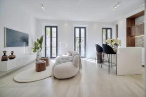 ein weißes Wohnzimmer mit einem weißen Sofa und Stühlen in der Unterkunft REF 1916 - Beautiful apartment for rent in Cannes in Cannes