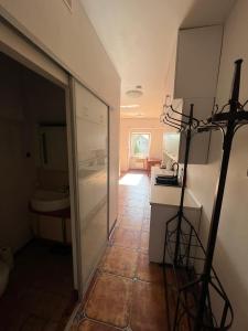 a kitchen with a glass door leading to a bathroom at Apartament Zloty Pociag in Wałbrzych