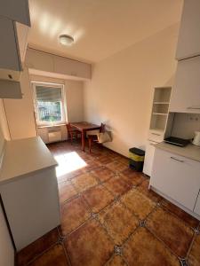 an empty kitchen with a table in the middle of it at Apartament Zloty Pociag in Wałbrzych +7 photos