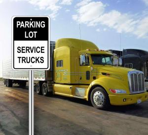 a yellow semi truck parked next to a sign at Philoxenia in Kavála