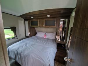 a large bed in the back of a caravan at American Rv - Dog friendly - Peaceful location in Sutton on Sea