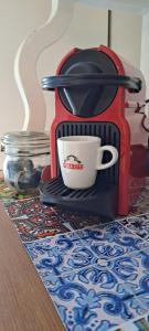 a coffee maker with a cup on a table at A casa di Vale in Lodi