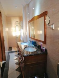 a bathroom with two sinks and a mirror at Sunset View La Cote D 'Azure in Pamplemousses Village
