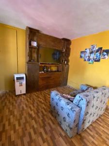 een woonkamer met een bank in de hoek van een kamer bij Casa en pinar del norte san luis in Barranca Colorada