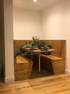 a table with a vase of flowers on top of it at Redhill Lodge in Farnham