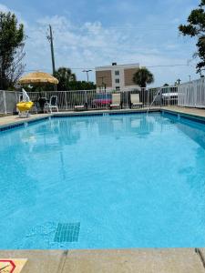 a large swimming pool with blue water at Days Inn by Wyndham Fort Walton Beach in Fort Walton Beach