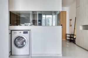 a washer and dryer in a room with at Cozy 2BR Apartment! in Singapore