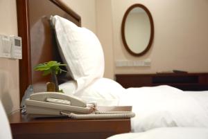Letto o letti in una camera di GreenTree Inn JiangSu WuXi YiXing East LongTan Road DongJiu Business Hotel