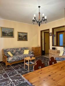 a living room with a couch and a table at Appartamento del Sole in Borno