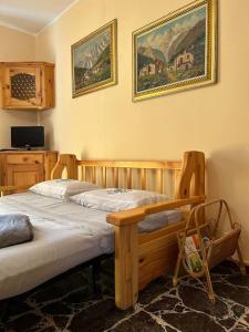a bedroom with two beds and a picture on the wall at Appartamento del Sole in Borno