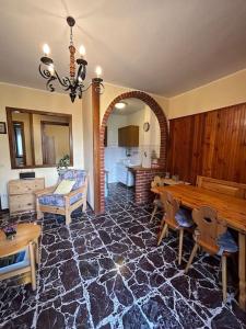 a living room with a table and a dining room at Appartamento del Sole in Borno