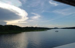 a view of a river with a boat on it at Hotel Pura Natura Riverside Tortuguero in Tortuguero +38 photos