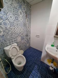 a bathroom with a toilet and a sink at SIGNATURE PARK GRANDE MT.Haryono in Jakarta