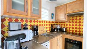 A kitchen or kitchenette at Atlantis, Magnifique T2, vue mer, proche plage, Anse Mitan