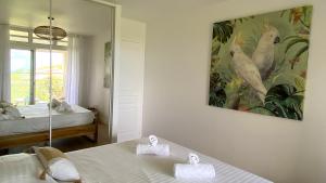 Una cama o camas en una habitación de Soley ka Chofé, Anse Mitan, Sublime T3 refait à neuf vue mer