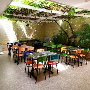 a group of tables and chairs in a restaurant at La Samaria Casa Linda in Santa Marta