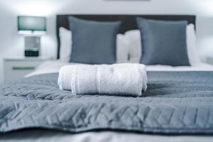 a white towel laying on top of a bed at Victoria Mill by Staycay in Wigan