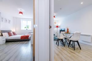 a living room with a bed and a table and chairs at Victoria Mill by Staycay in Wigan