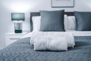 a bed with two white towels on top of it at Victoria Mill by Staycay in Wigan