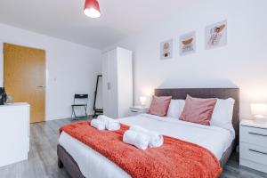 a bedroom with a large bed with towels on it at Victoria Mill by Staycay in Wigan
