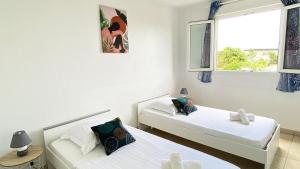 Letto o letti in una camera di Ti Bonheur