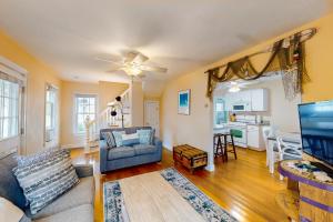a living room with a couch and a tv at Onset Grove in Onset