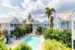an image of a villa with a swimming pool and houses at Baya House in Key West
