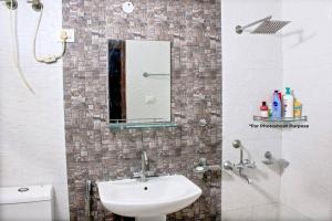 a bathroom with a sink and a mirror at Atithi Stay By Kasa Lusso - Luxury 2 BHK In Faridabad in Faridabad