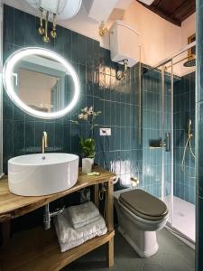 a bathroom with a sink and a toilet and a mirror at DomusLu' - Casa di charme nel cuore di Roma in Rome