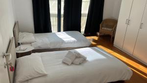 a room with two beds and a window at Yellow House Guest House in Mendrisio