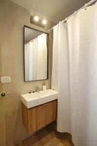 a bathroom with a white sink and a mirror at Fancy 1BR Apartment in Nuñez in Buenos Aires