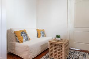 a living room with a white couch and a table at Old Town - Boutique Hall Square Apartment in Tallinn