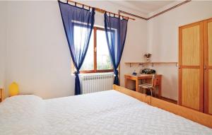 a bedroom with a large bed and a window at Petrcane house in Petrcane