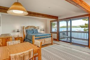 a bedroom with a bed and a table and a balcony at Our Lake House in Zephyr Cove